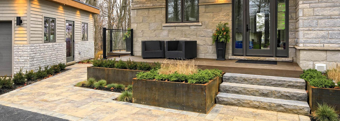 Deck over concrete patio on furnished patio with glass doors and planters