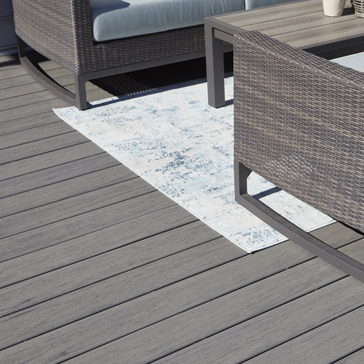 Close-up of Driftwood gray composite decking under a lounge area