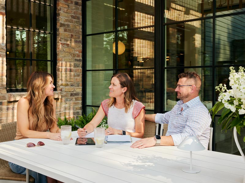 Elizabeth and Scott chat with a friend at their home