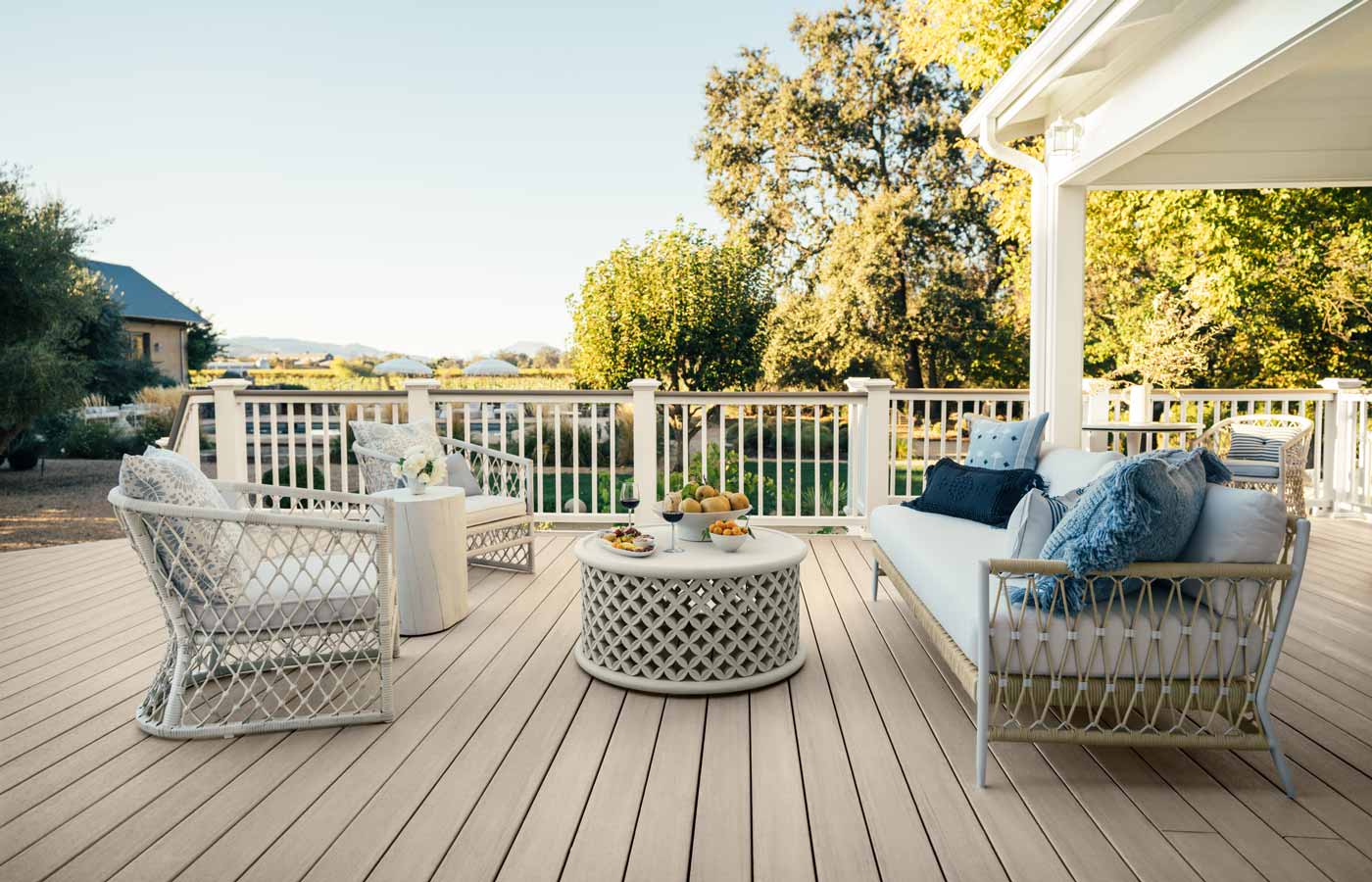 Light gray, woven patio furniture is set up in preparation to entertain guests