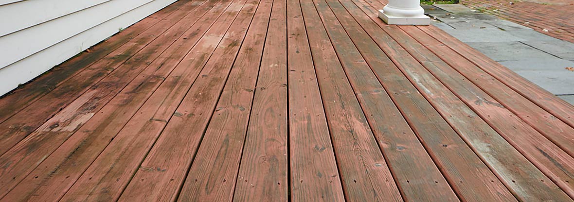 Image of old, work wood decking exposed to water. 