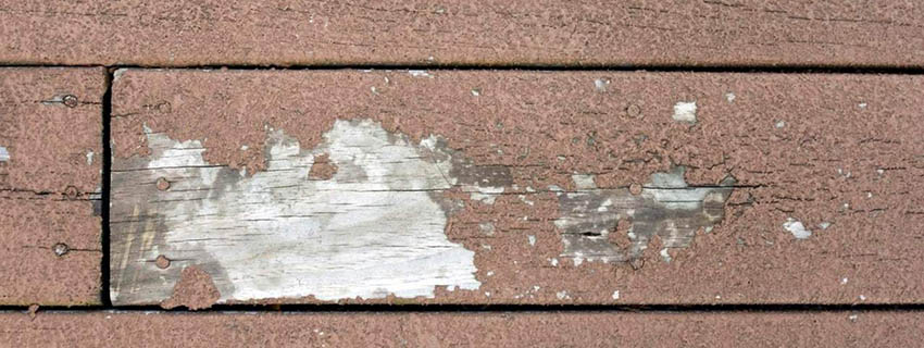 Wood deck stain that has cracked and faded.